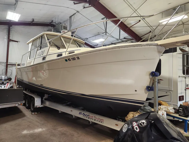 Slide: The Image of 2010 Mainship Pilot 31 boat on trailer in indoor storage facility. - 5