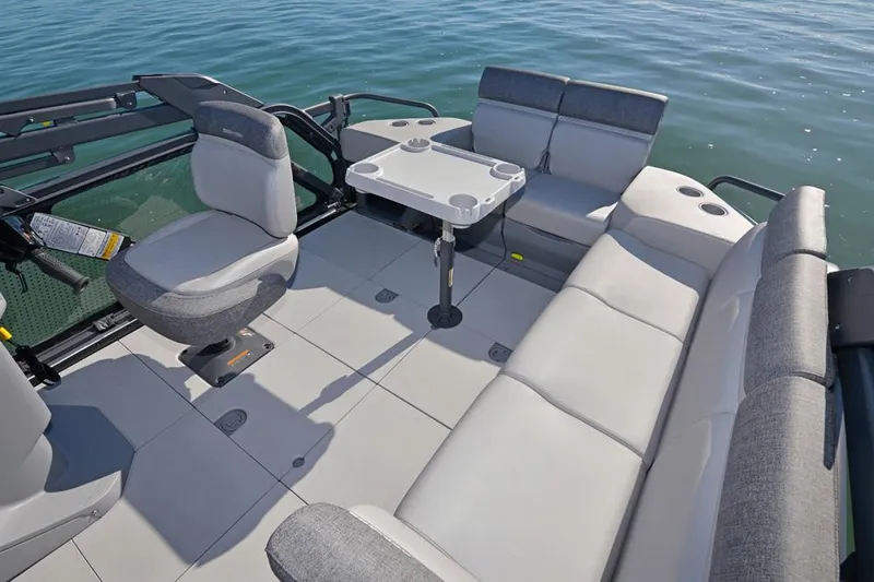 Slide: The Image of Interior of 2024 Sea-Doo Switch® Sport 21 boat with seating and table on water. - 9