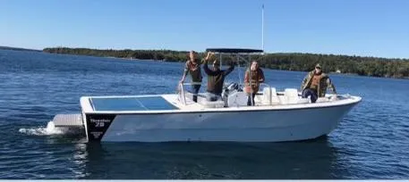 Slide: The Image of 1999 Sea Ray Thresher boat with passengers on a calm lake under clear blue skies. - 1