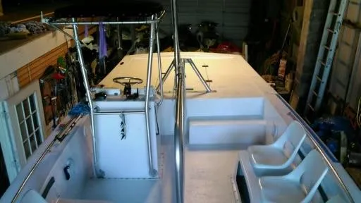 Slide: The Image of 1999 Sea Ray Thresher boat interior with seating and steering console in a garage. - 3