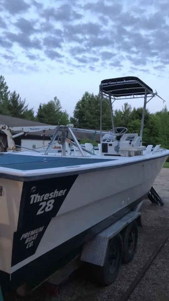 Slide: The Image of 1999 Sea Ray Thresher boat on trailer, under cloudy sky, side view. - 6