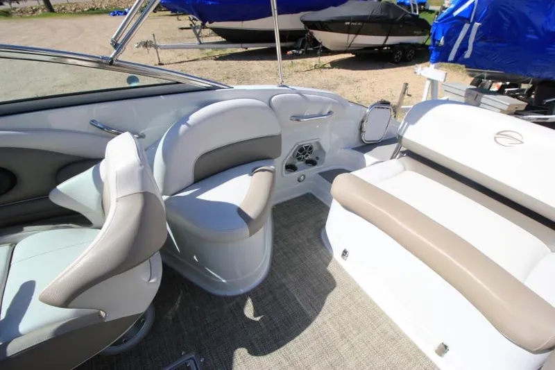 Slide: The Image of Interior of 2016 Crownline Eclipse E2 boat with beige and white seating. - 10