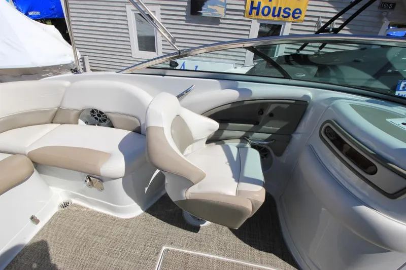 Slide: The Image of 2016 Crownline Eclipse E2 boat interior with beige seating and modern dashboard. - 12