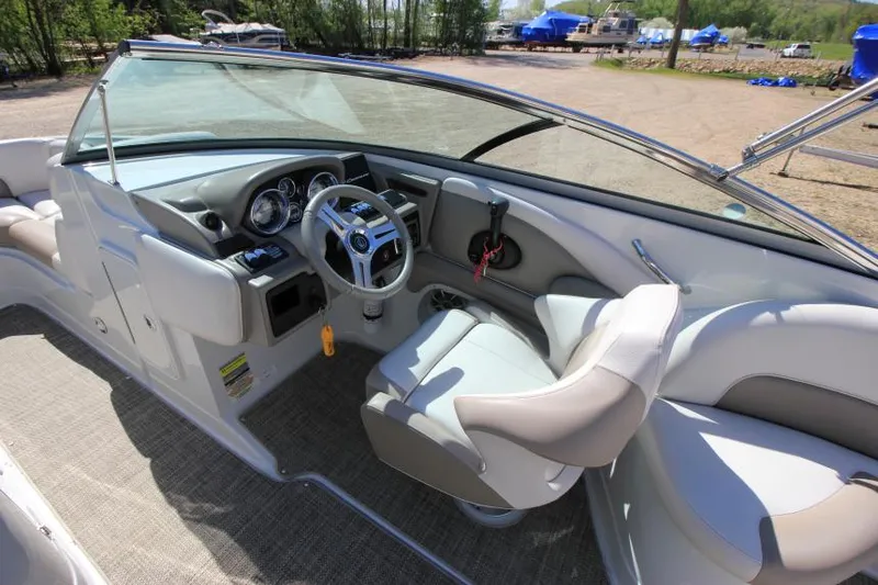 Slide: The Image of 2016 Crownline Eclipse E2 boat interior with steering wheel and seating. - 13