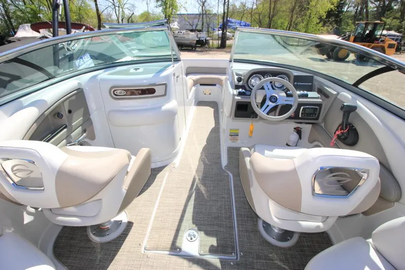 Slide: The Image of 2016 Crownline Eclipse E2 boat interior with beige seating and modern dashboard. - 16