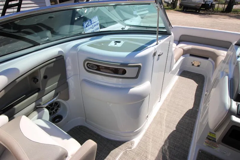 Slide: The Image of 2016 Crownline Eclipse E2 boat interior with seating and dashboard, for sale sign visible. - 17
