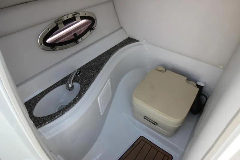 Slide: The Image of 2016 Crownline Eclipse E2 boat interior with sink and portable toilet. - 18