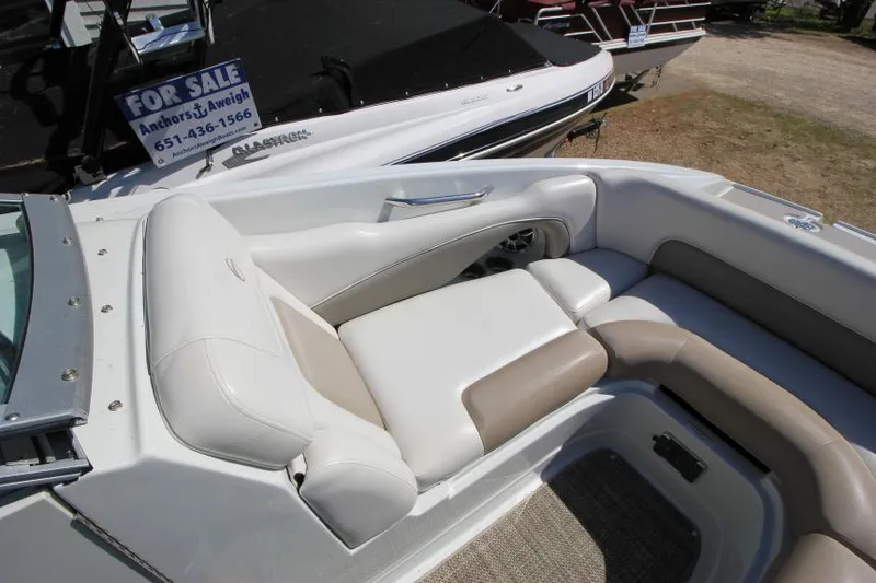 Slide: The Image of 2016 Crownline Eclipse E2 boat interior with beige and white seating, for sale sign visible. - 20