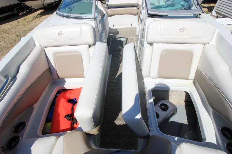 Slide: The Image of 2016 Crownline Eclipse E2 boat interior with beige seating and storage compartments. - 24