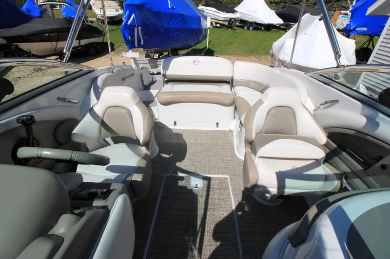 Slide: The Image of 2016 Crownline Eclipse E2 boat interior with beige seating and carpeted floor. - 26