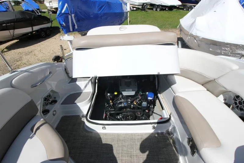 Slide: The Image of 2016 Crownline Eclipse E2 boat engine compartment with open hatch, showcasing interior seating. - 29