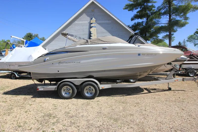 Slide: The Image of 2016 Crownline Eclipse E2 boat on trailer, parked outdoors near a house. - 4