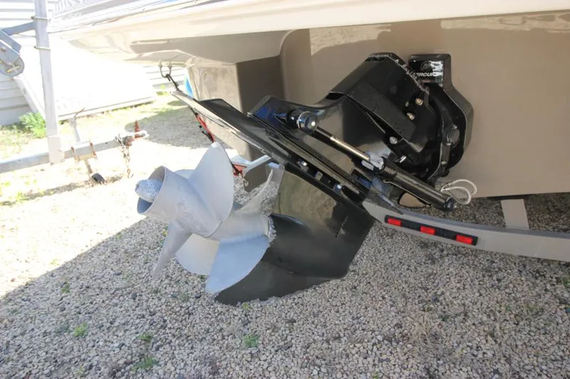 Slide: The Image of 2016 Crownline Eclipse E2 boat propeller and outdrive on gravel surface. - 5