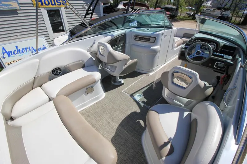 Slide: The Image of 2016 Crownline Eclipse E2 boat interior with beige seating and modern dashboard. - 8