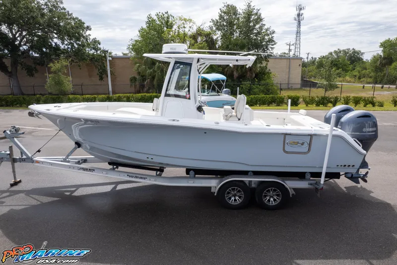 Slide: The Image of 2022 Sea Hunt GAMEFISH 27 CB boat on trailer, side view, outdoors. - 10