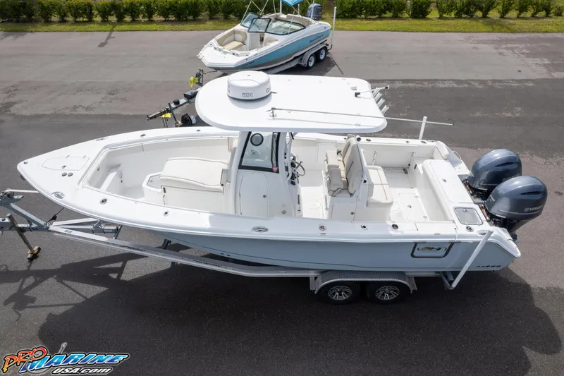 Slide: The Image of 2022 Sea Hunt GAMEFISH 27 CB boat on trailer, dual engines, white exterior. - 12