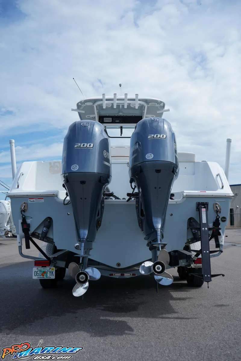 Slide: The Image of 2022 Sea Hunt GAMEFISH 27 CB with dual 200 horsepower engines, rear view. - 13