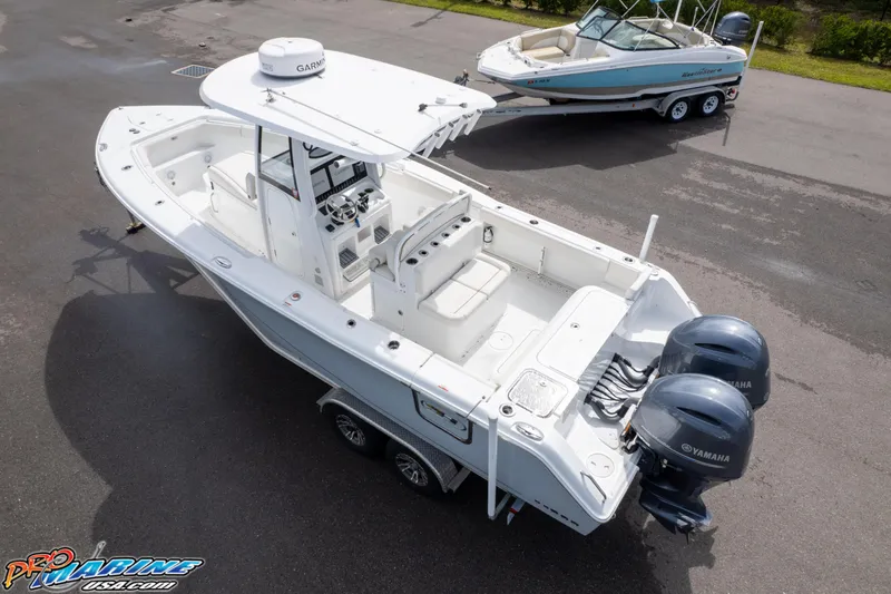 Slide: The Image of 2022 Sea Hunt GAMEFISH 27 CB boat with dual Yamaha engines on a trailer. - 16