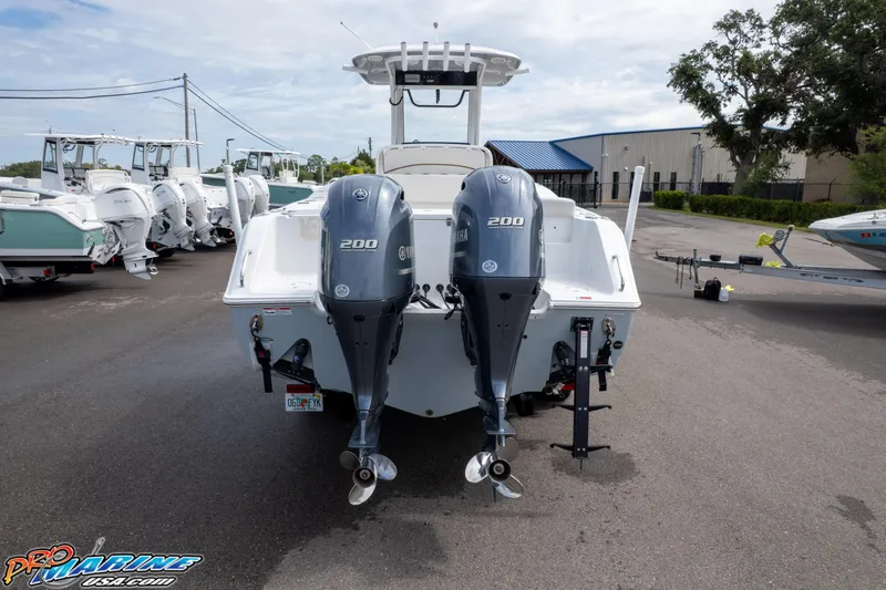 Slide: The Image of 2022 Sea Hunt GAMEFISH 27 CB with dual 200 horsepower engines at a marina. - 18