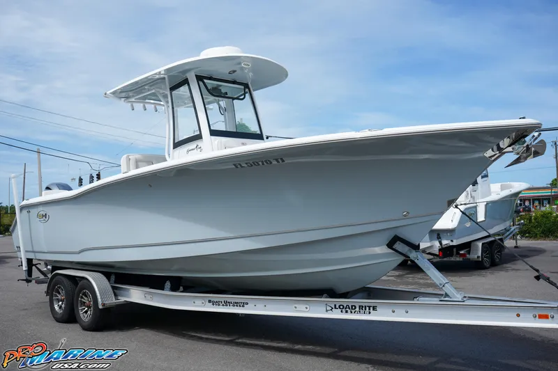 Slide: The Image of 2022 Sea Hunt GAMEFISH 27 CB boat on trailer, side view, outdoors. - 19