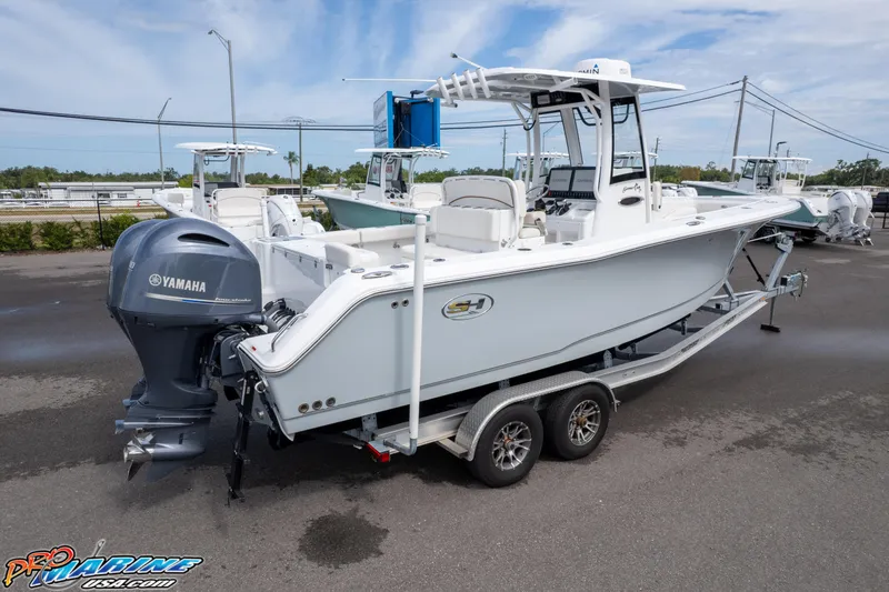 Slide: The Image of 2022 Sea Hunt GAMEFISH 27 CB boat on trailer, featuring Yamaha outboard motor. - 22