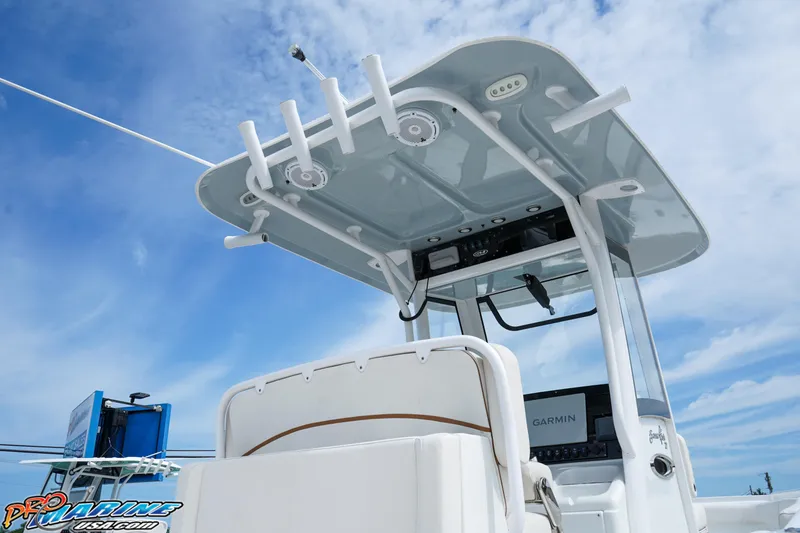 Slide: The Image of 2022 Sea Hunt GAMEFISH 27 CB boat with T-top and Garmin electronics against blue sky. - 23