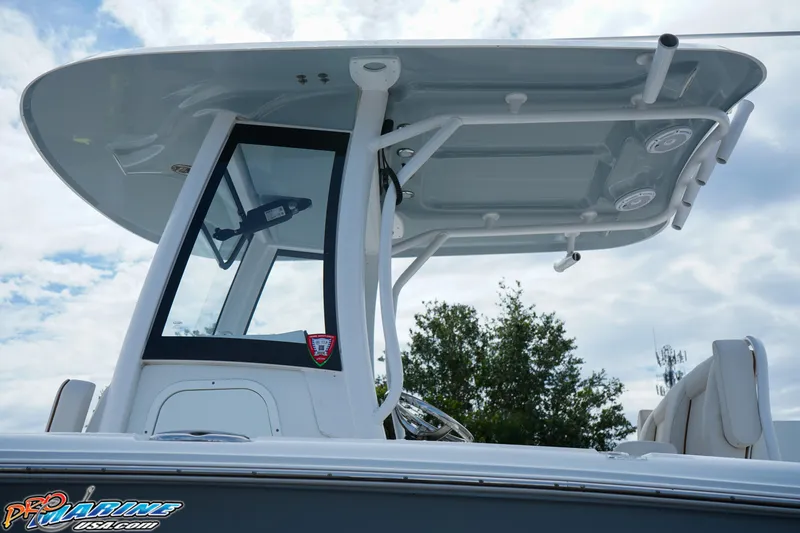 Slide: The Image of 2022 Sea Hunt GAMEFISH 27 CB boat with T-top and console, under a cloudy sky. - 25