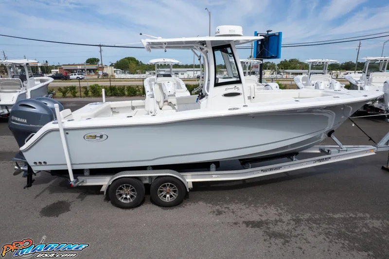 Slide: The Image of 2022 Sea Hunt GAMEFISH 27 CB boat on trailer, side view, outdoors. - 26