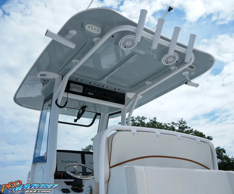 Slide: The Image of 2022 Sea Hunt GAMEFISH 27 CB boat with T-top and rod holders under a blue sky. - 27