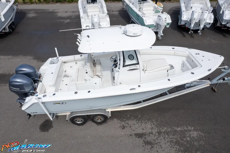 Slide: The Image of 2022 Sea Hunt GAMEFISH 27 CB boat on trailer, aerial view, white exterior. - 28