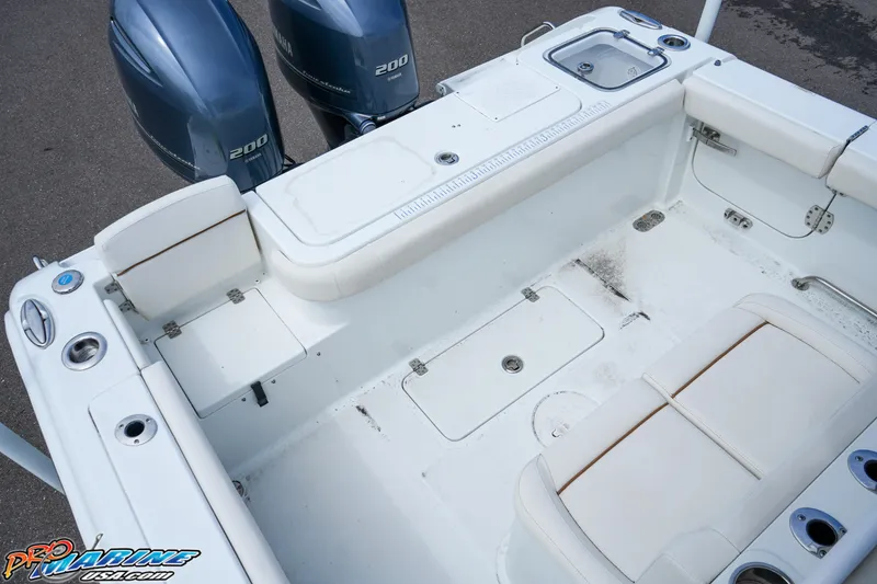 Slide: The Image of 2022 Sea Hunt GAMEFISH 27 CB boat interior with dual engines and seating area. - 29