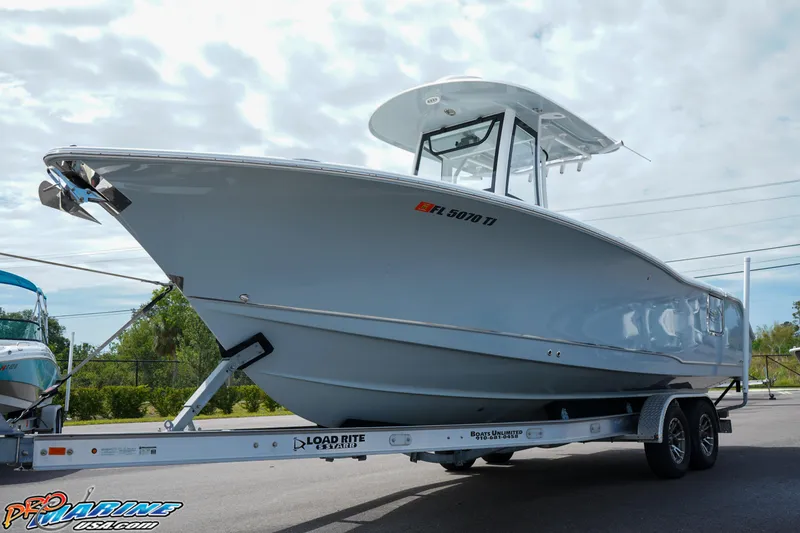 Slide: The Image of 2022 Sea Hunt GAMEFISH 27 CB boat on trailer, side view, outdoors. - 3