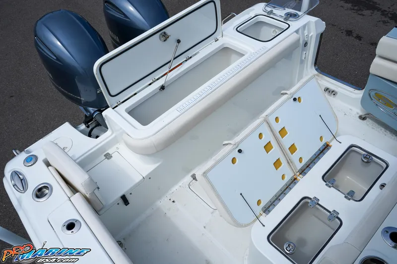 Slide: The Image of 2022 Sea Hunt GAMEFISH 27 CB boat deck with storage compartments and dual engines. - 31