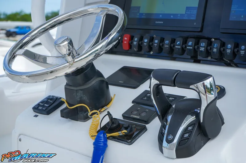 Slide: The Image of 2022 Sea Hunt GAMEFISH 27 CB helm with steering wheel and controls. - 38