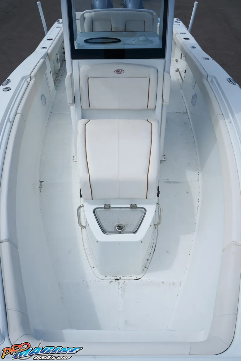 Slide: The Image of 2022 Sea Hunt GAMEFISH 27 CB boat interior, featuring spacious white deck and seating. - 42