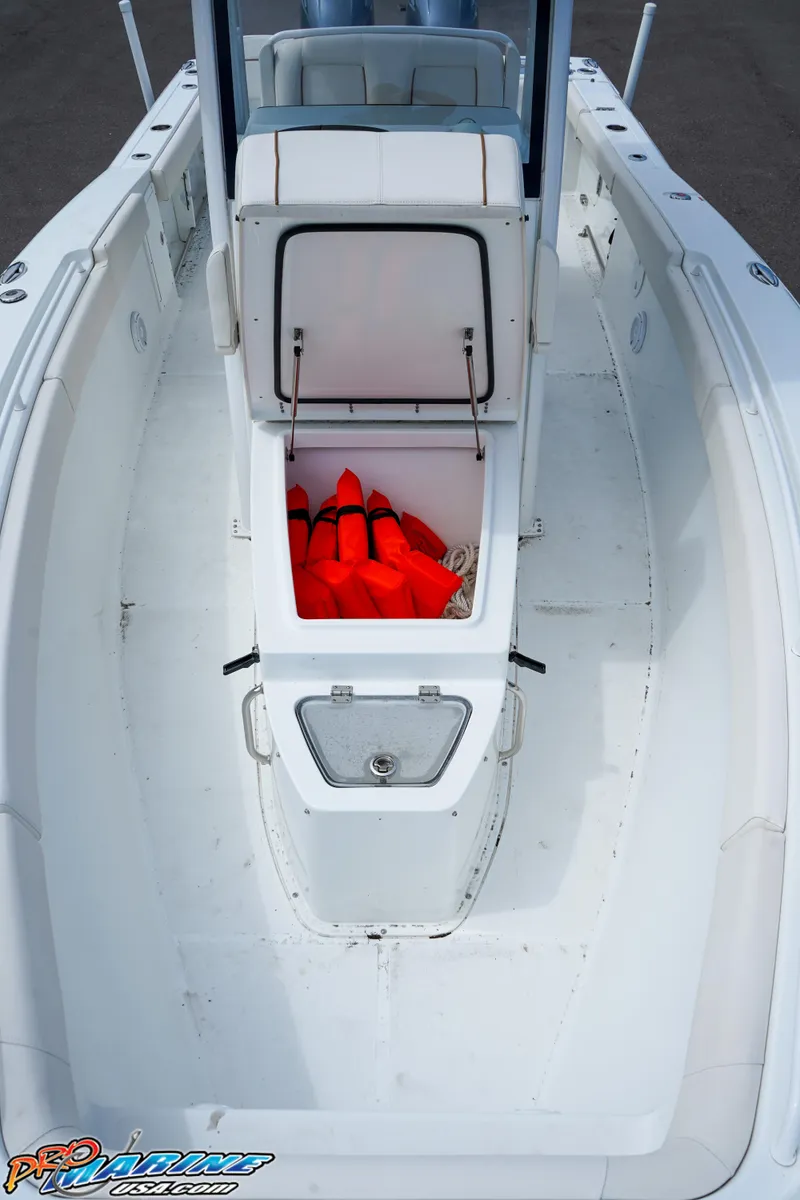 Slide: The Image of 2022 Sea Hunt GAMEFISH 27 CB boat with open storage compartment and life jackets. - 43