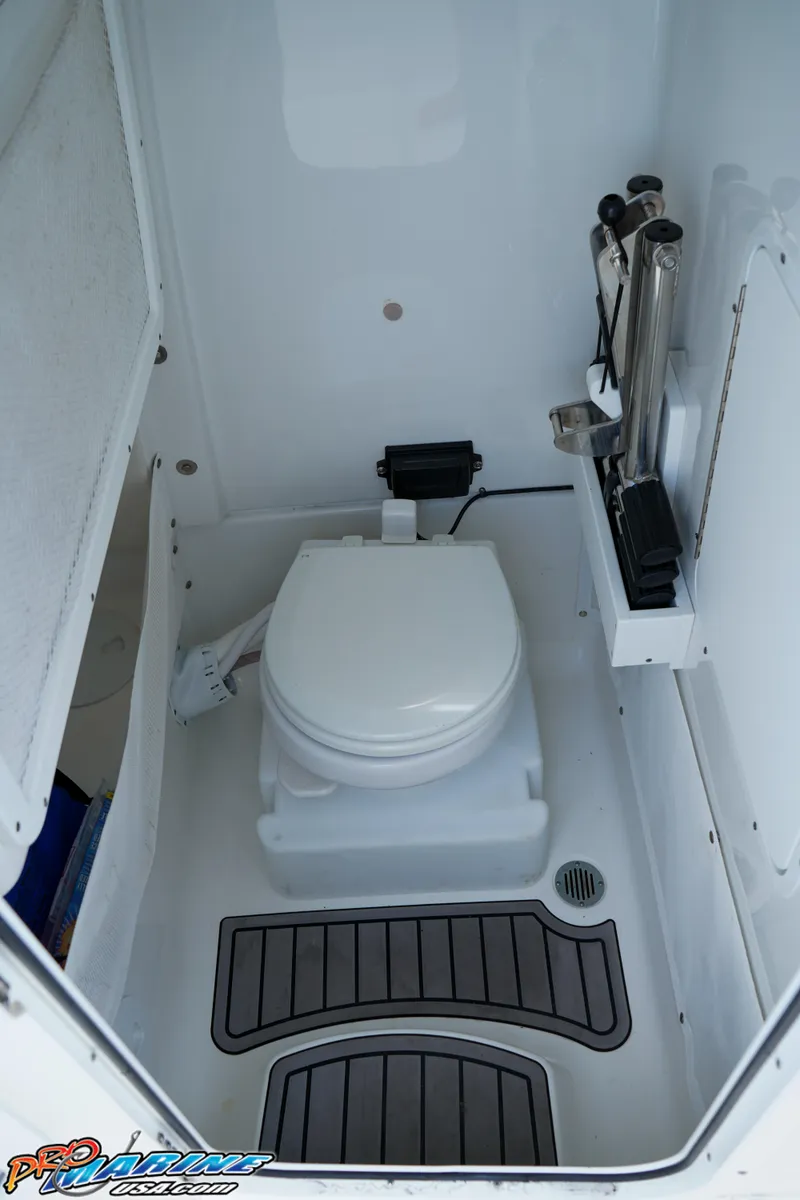 Slide: The Image of 2022 Sea Hunt GAMEFISH 27 CB boat interior with compact marine toilet. - 46