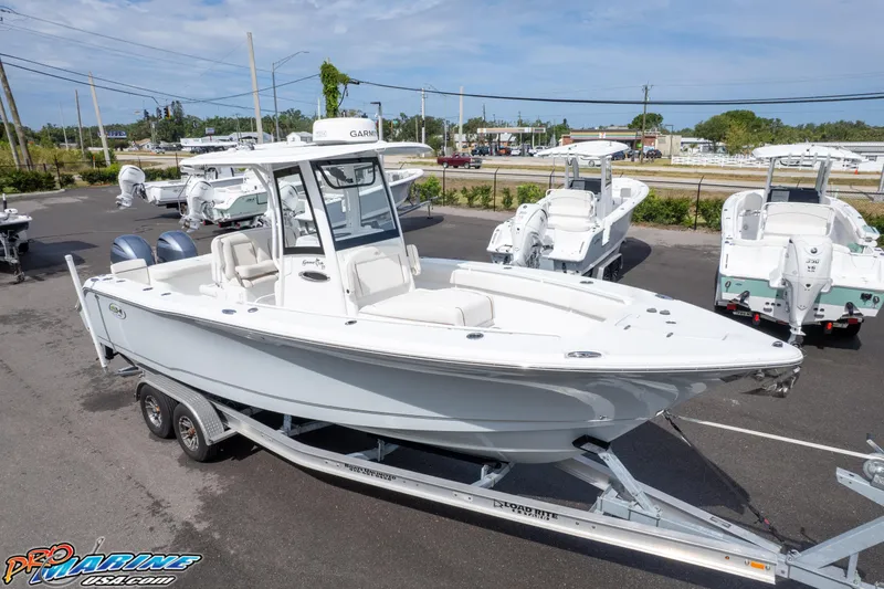 Slide: The Image of 2022 Sea Hunt GAMEFISH 27 CB boat on trailer in a dealership lot. - 47