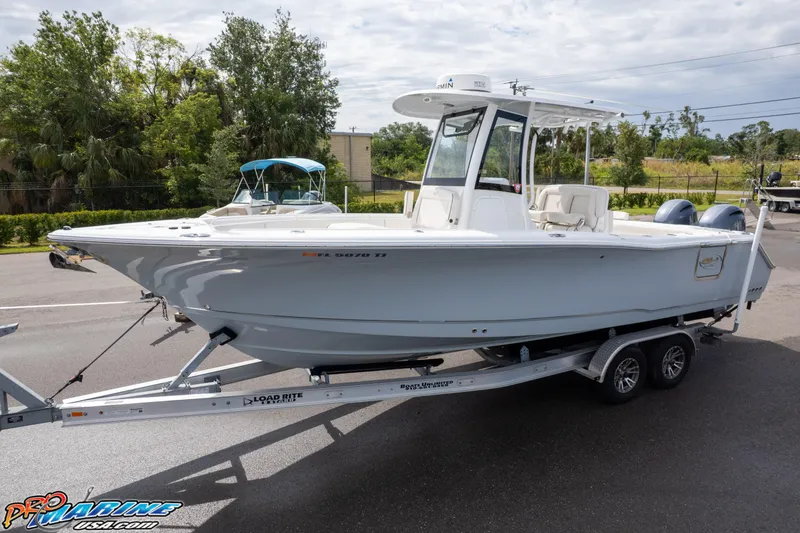 Slide: The Image of 2022 Sea Hunt GAMEFISH 27 CB boat on trailer, parked outdoors. - 6