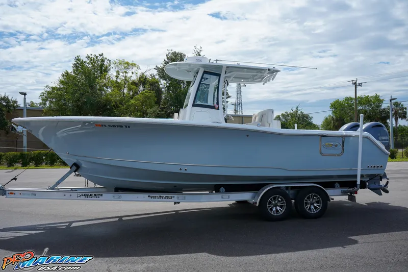 Slide: The Image of 2022 Sea Hunt GAMEFISH 27 CB boat on trailer, parked outdoors. - 7