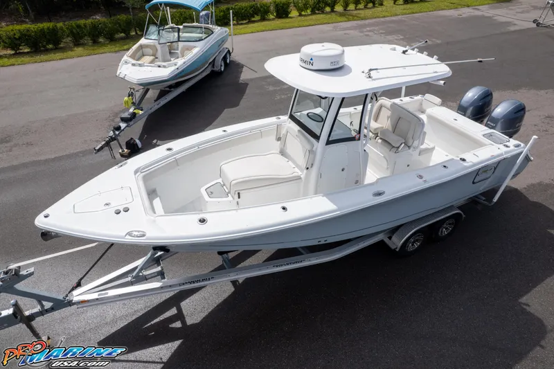 Slide: The Image of 2022 Sea Hunt GAMEFISH 27 CB boat on trailer, parked outdoors. - 8