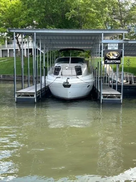 The Image of 2005 Carver Mariner 360 docked under a covered slip on a calm lake. - 0