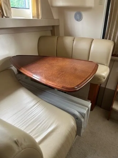 Slide: The Image of 2005 Carver Mariner 360 interior with beige seating and wooden table. - 22