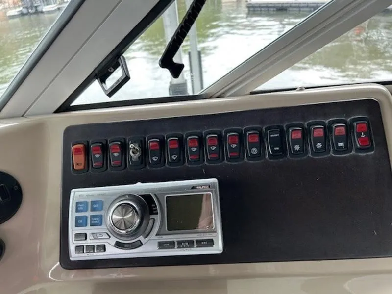 Slide: The Image of Control panel of a 2005 Carver Mariner 360 boat with switches and stereo system. - 6