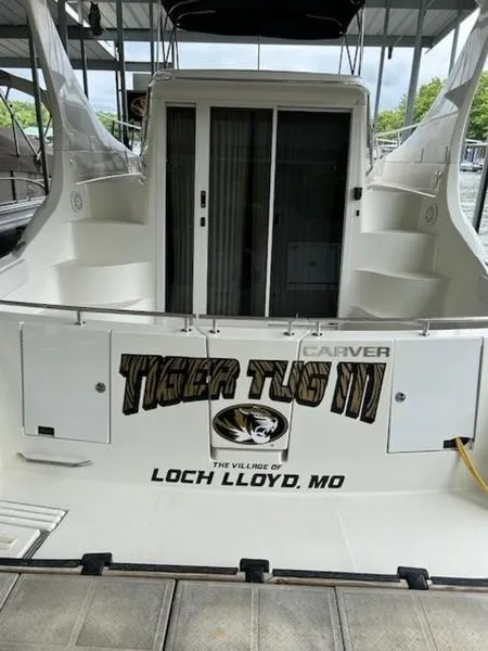 Slide: The Image of 2005 Carver Mariner 360 boat docked, featuring "Tiger Tug III" and "Loch Lloyd, MO" text. - 10