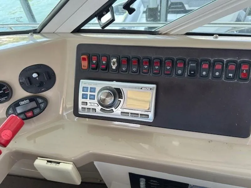 Slide: The Image of Control panel of a 2005 Carver Mariner 360 boat with various switches and dials. - 18