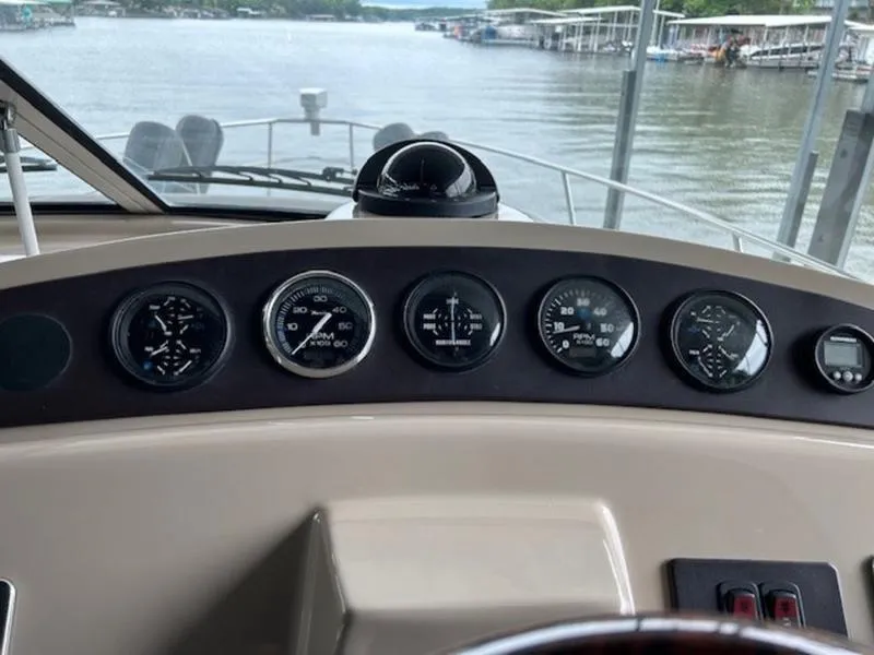 Slide: The Image of Dashboard of a 2005 Carver Mariner 360 boat with gauges and compass. - 2