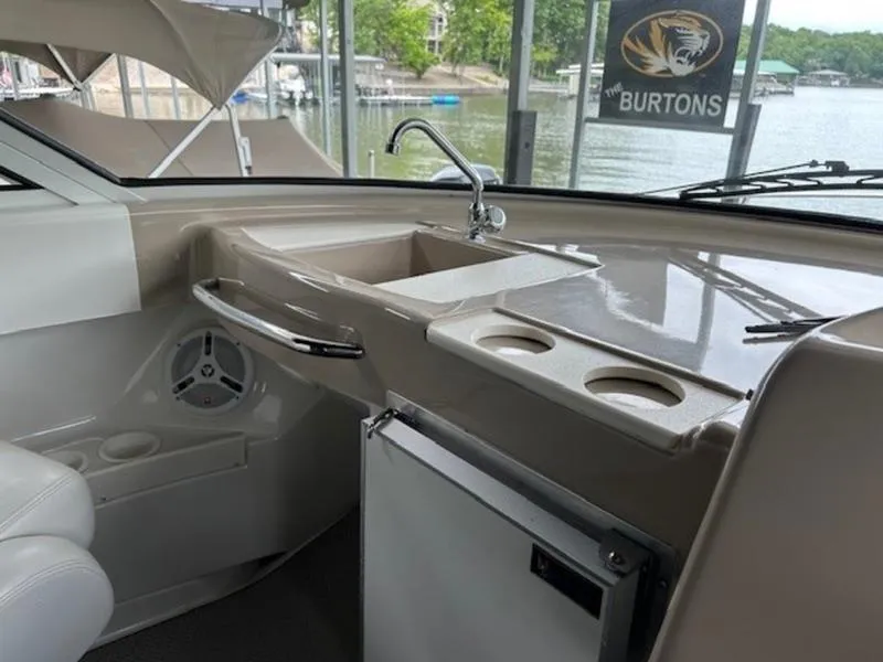 Slide: The Image of 2005 Carver Mariner 360 boat interior with sink, cup holders, and scenic lake view. - 5