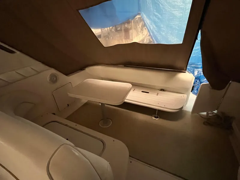 Slide: The Image of 1996 Sea Ray 330 Sundancer cabin interior with seating and table. - 10