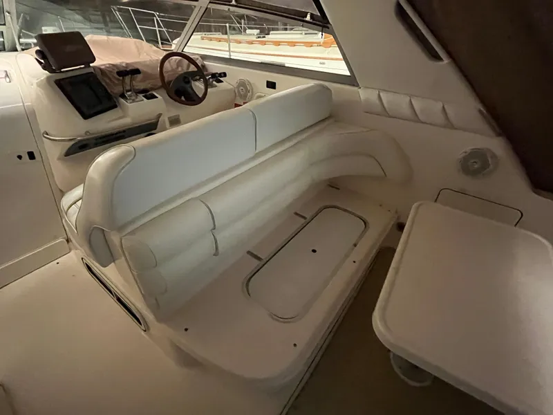Slide: The Image of 1996 Sea Ray 330 Sundancer interior with white seating and helm station. - 11